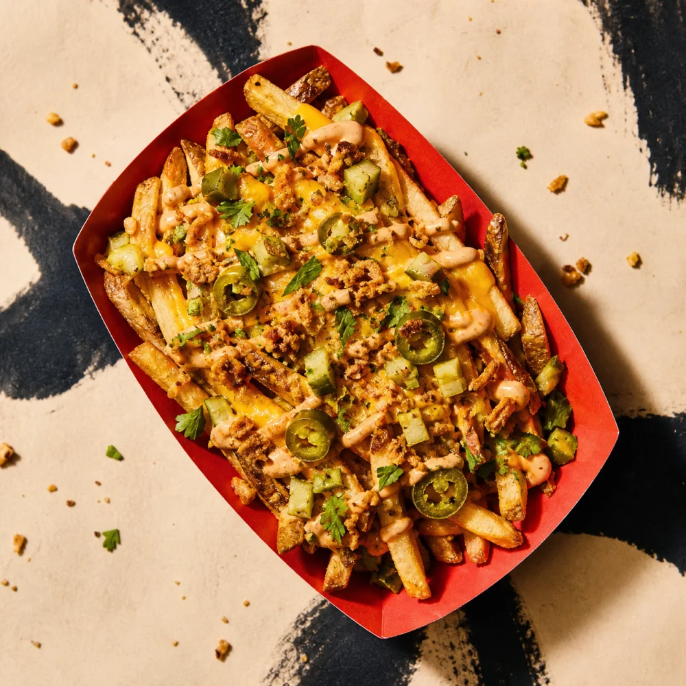 Tray of loaded fries with cheddar, jalapeno and crispy onions